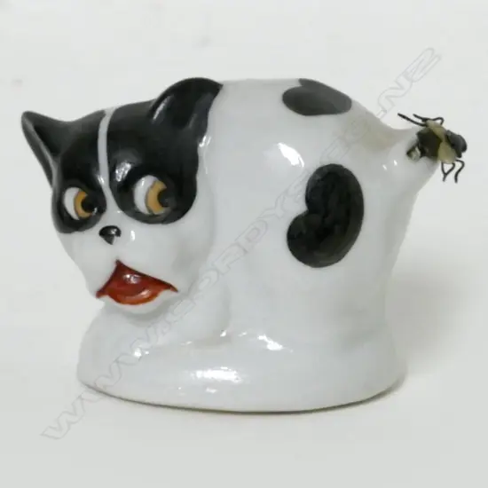 A Victorian novelty china dog with fly tape measure