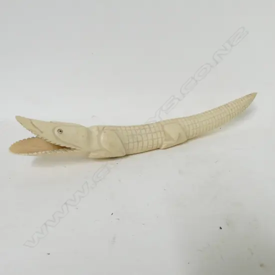 An African ivory tusk carved as a crocodile