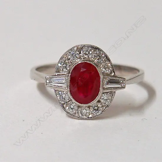 A lady's 18ct. white gold ruby and diamond cluster ring