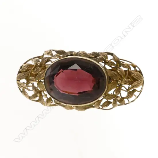 A late 19thC 9ct. yellow gold and purple stone brooch