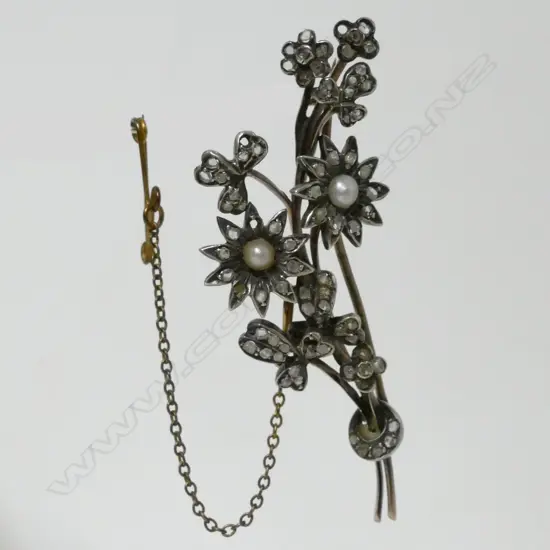 A gold seed pearl and diamond floral brooch