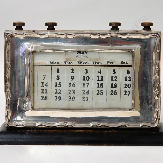 A 1930s silver fronted desk calendar