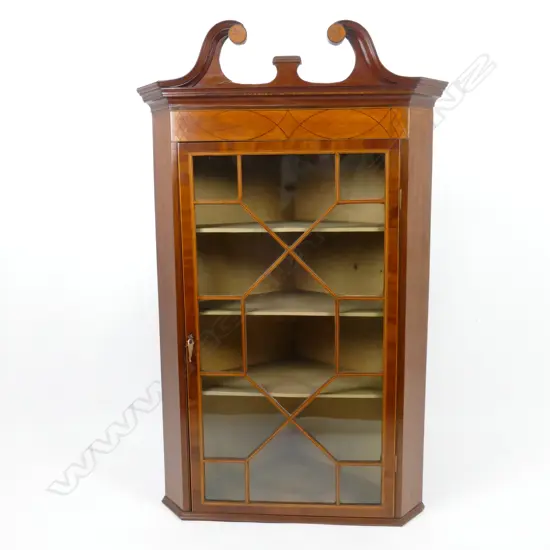 A Georgian mahogany hanging corner cabinet with an astragal glazed door