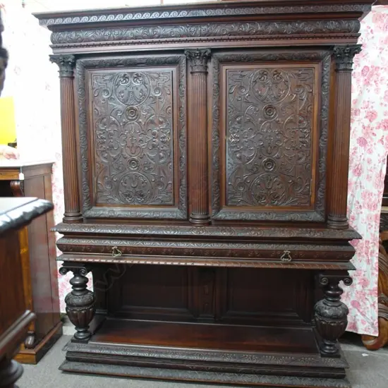 A large ornately carved late 19thC European court cupboard