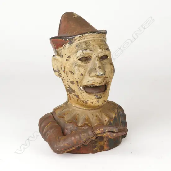 An antique cast iron clown money box