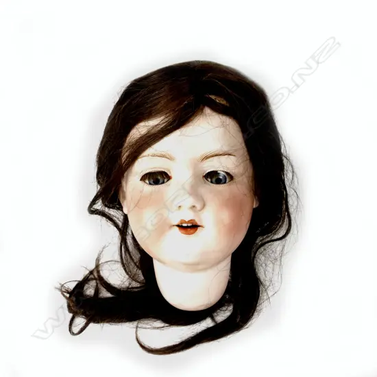 The bisque head of an Armand Marseille doll with sleeping blue glass paperweight eyes