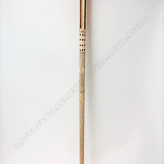 A 19thC decorated whalebone walking stick with later sculpted greenstone handle