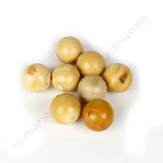 Eight small old ivory balls