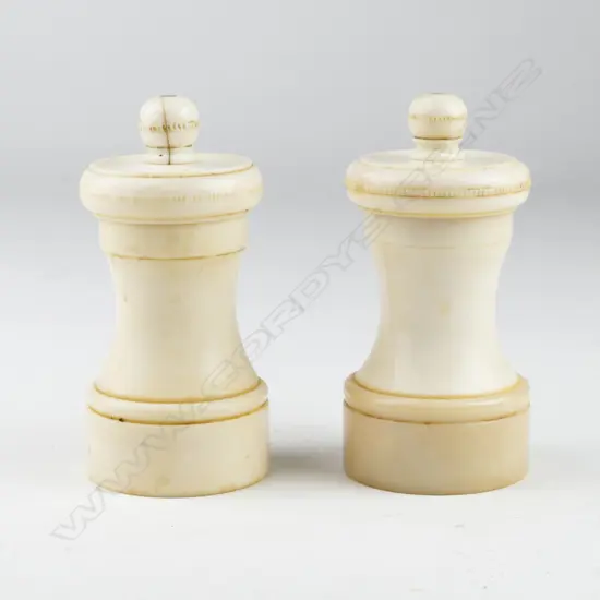 A pair of antique ivory pepper mills