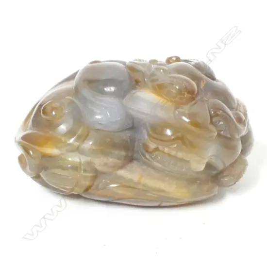 A Chinese carved agate recumbent lion dog