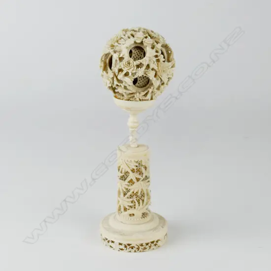 A Chinese ivory puzzle ball on stand
