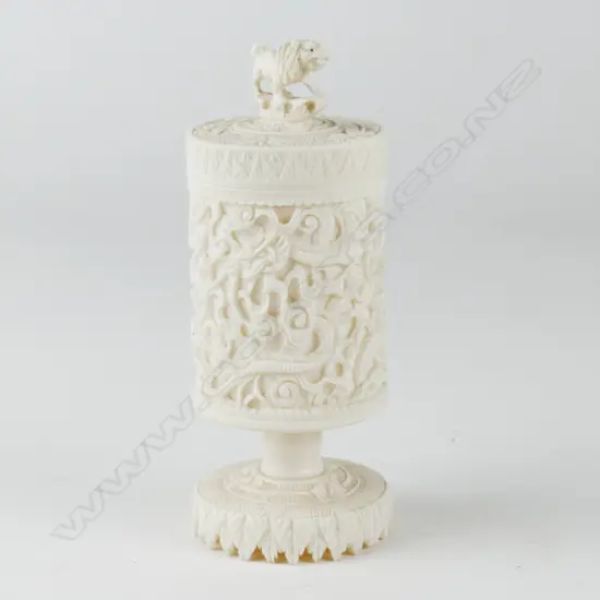 A Chinese carved cylindrical ivory canister on pedestal base