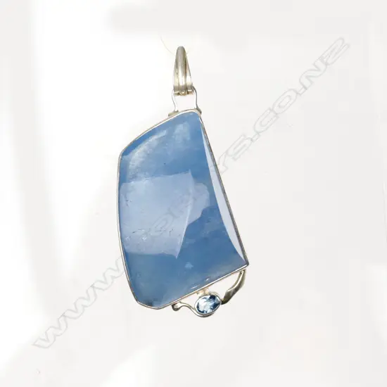 A large polished aquamarine and silver modern pendant