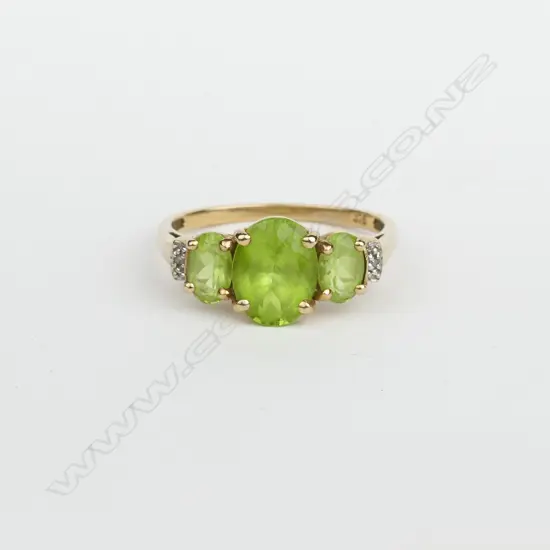 An estate 9ct. yellow gold peridot and diamond dress ring