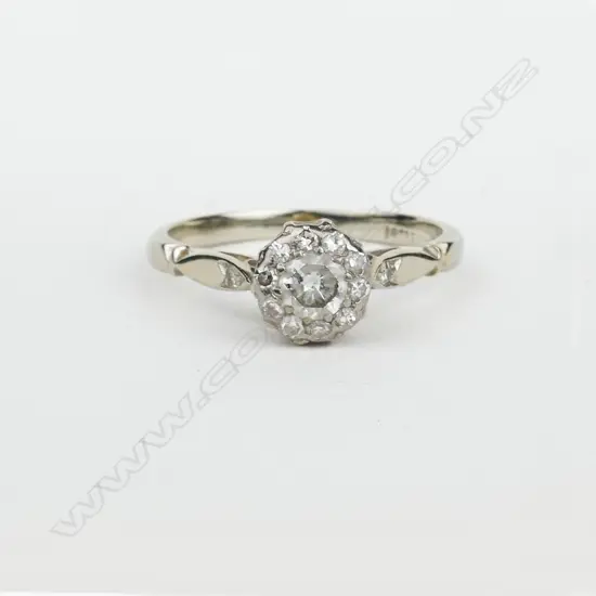 An early 20thC 18ct. white gold and diamond dress ring