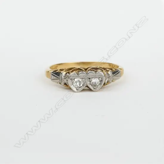 An early 20thC 18ct. yellow gold platinum and diamond twin heart ring