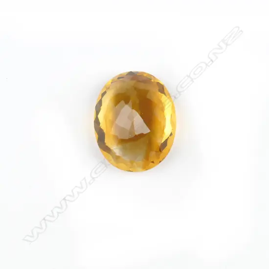 A large facet cut oval citrine gemstone