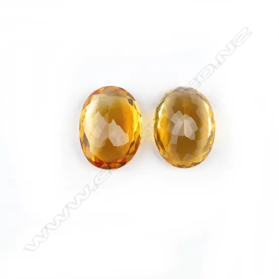 A pair of oval facet cut citrine gemstones