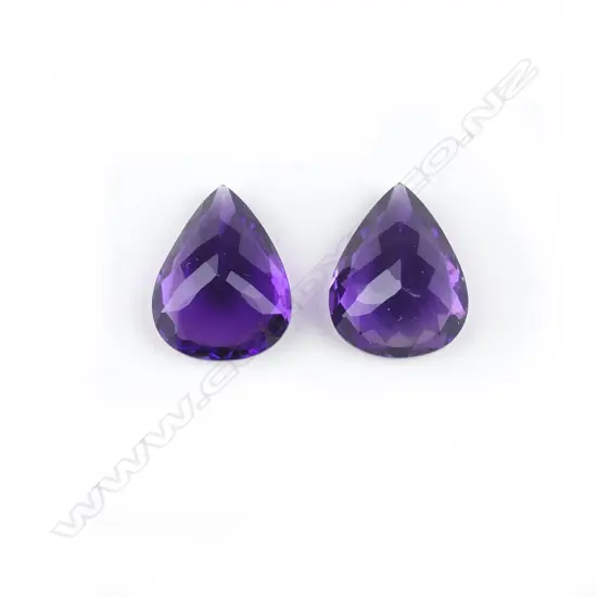 A pair of amethyst pear-cut gemstones