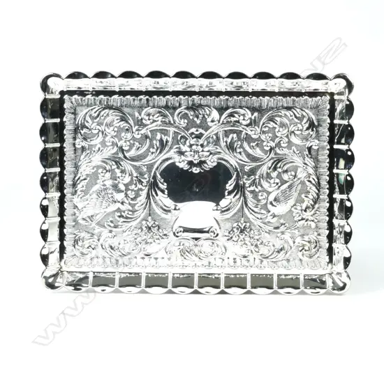 A silver dressing table tray
