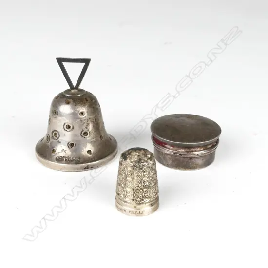 A silver bell shaped pin cushion
