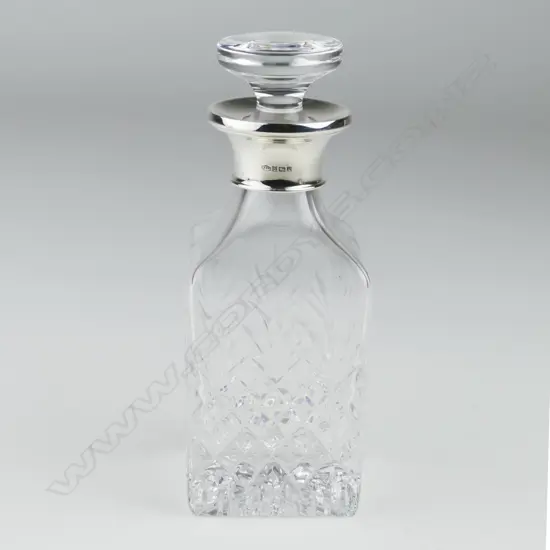 A modern silver and glass perfume bottle
