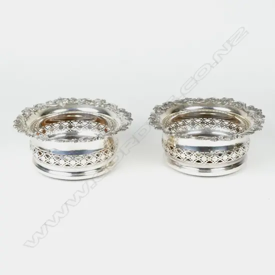 A pair of silver plate on copper wine coasters