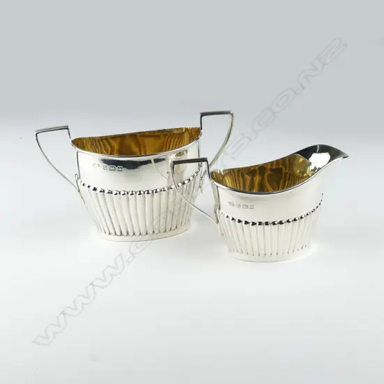 An early 1900 silver cream and sugar