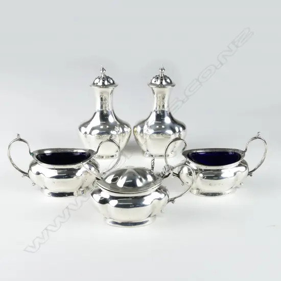 An early 1900s silver condiment set
