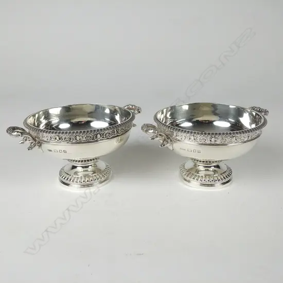 A pair of heavy silver two-handled circular stem dishes