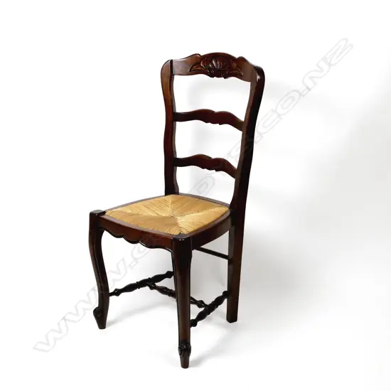 A set of ten oak French ladderback dining chairs