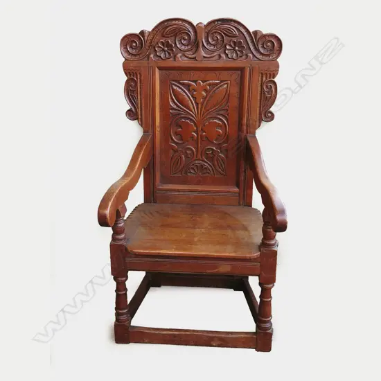 A Victorian oak elbow chair