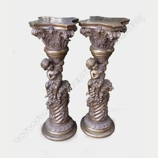 A matching pair of bronze stands with acanthus leaf plinth capitals