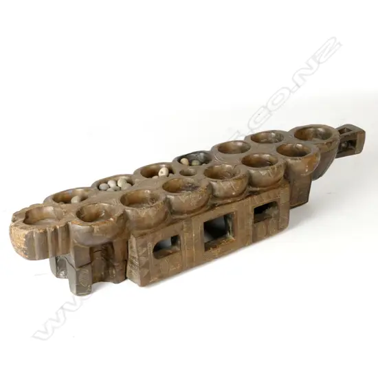 An old African Ivory Coast awalé board game 'table' and 46 nickernuts