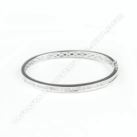 An 18ct. white gold and diamond bangle