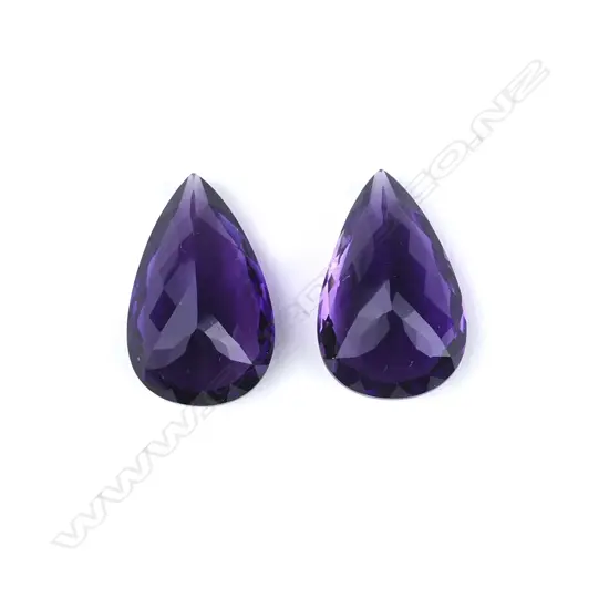 A pair of amethyst pear-cut gemstones