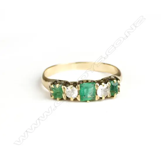 An estate 18ct. yellow gold emerald and diamond dress ring
