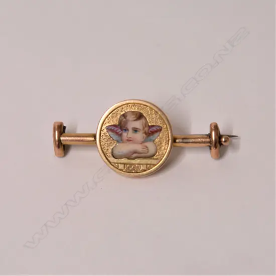 A 19thC 15ct. yellow gold and cherub enamelled brooch