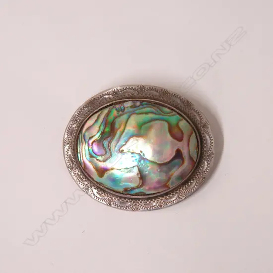 A vintage silver and paua oval brooch