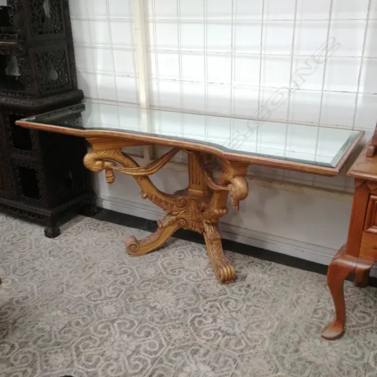 An ornate French style gilded and mirrored console table