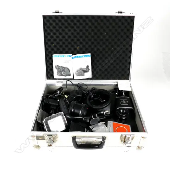 A large Linhof aluminium camera case containing assorted Hasselblad accessories
