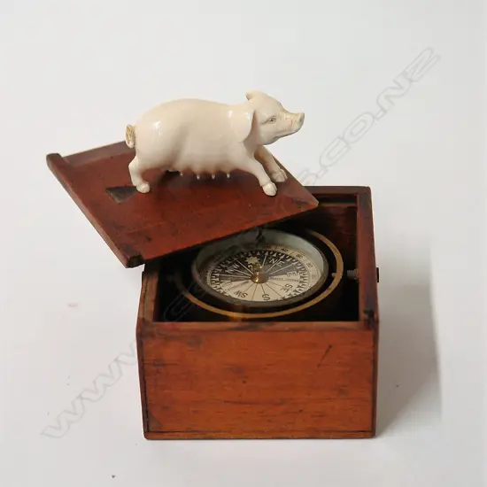 A c.1900 small gimballed compass and finely carved ivory pig