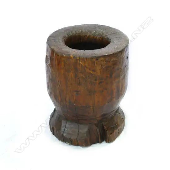 A large wooden grain pounding pot