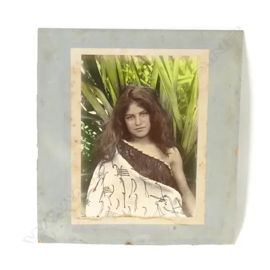 An early 20thC hand coloured photo of a young Maori girl