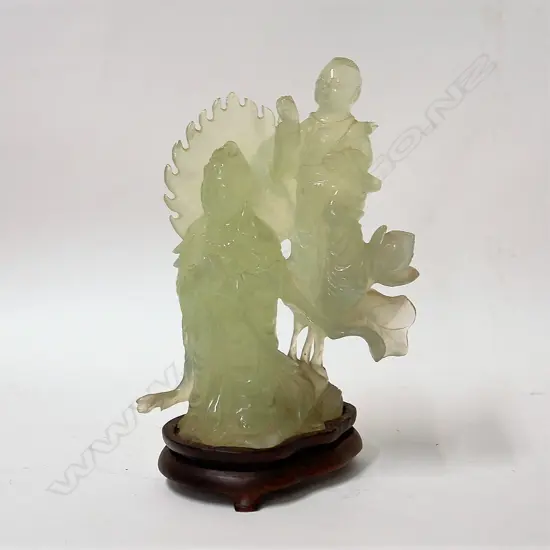 A Chinese carved pale jade figure group of a praying deity with boy attendant