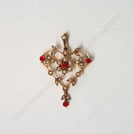 An Edwardian 9ct. yellow gold ruby and seed pearl pendant/brooch