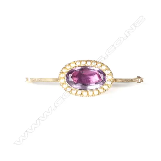 An antique 9ct. rose gold amethyst and seed pearl brooch