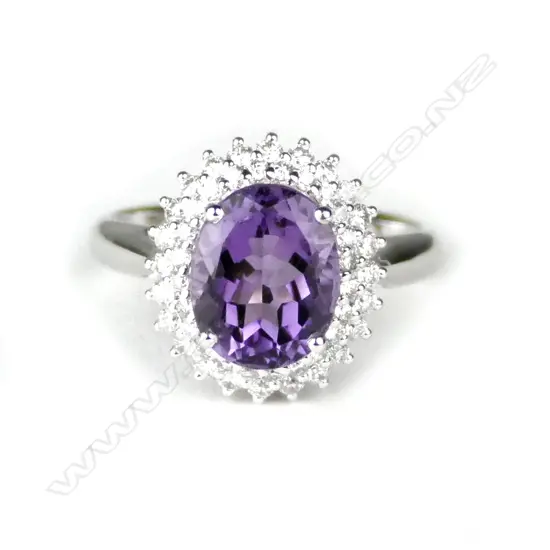 A lady's modern 18ct. white gold amethyst and diamond cluster ring