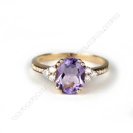 A lady's modern 18ct. rose gold amethyst and diamond ring