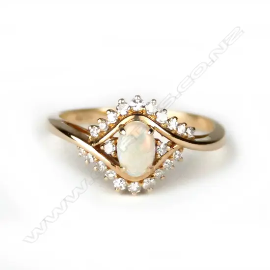 A modern 18ct. yellow gold opal and diamond dress ring